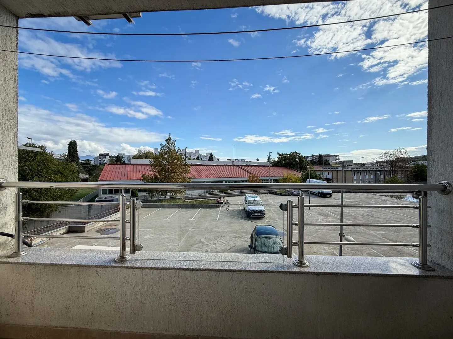 View from the terrace overlooking the parking lot and surrounding buildings.
