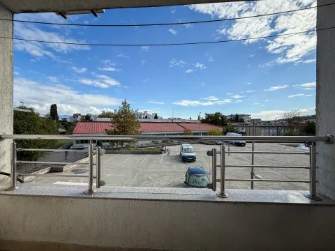 View from the terrace overlooking the parking lot and surrounding buildings. - image 8