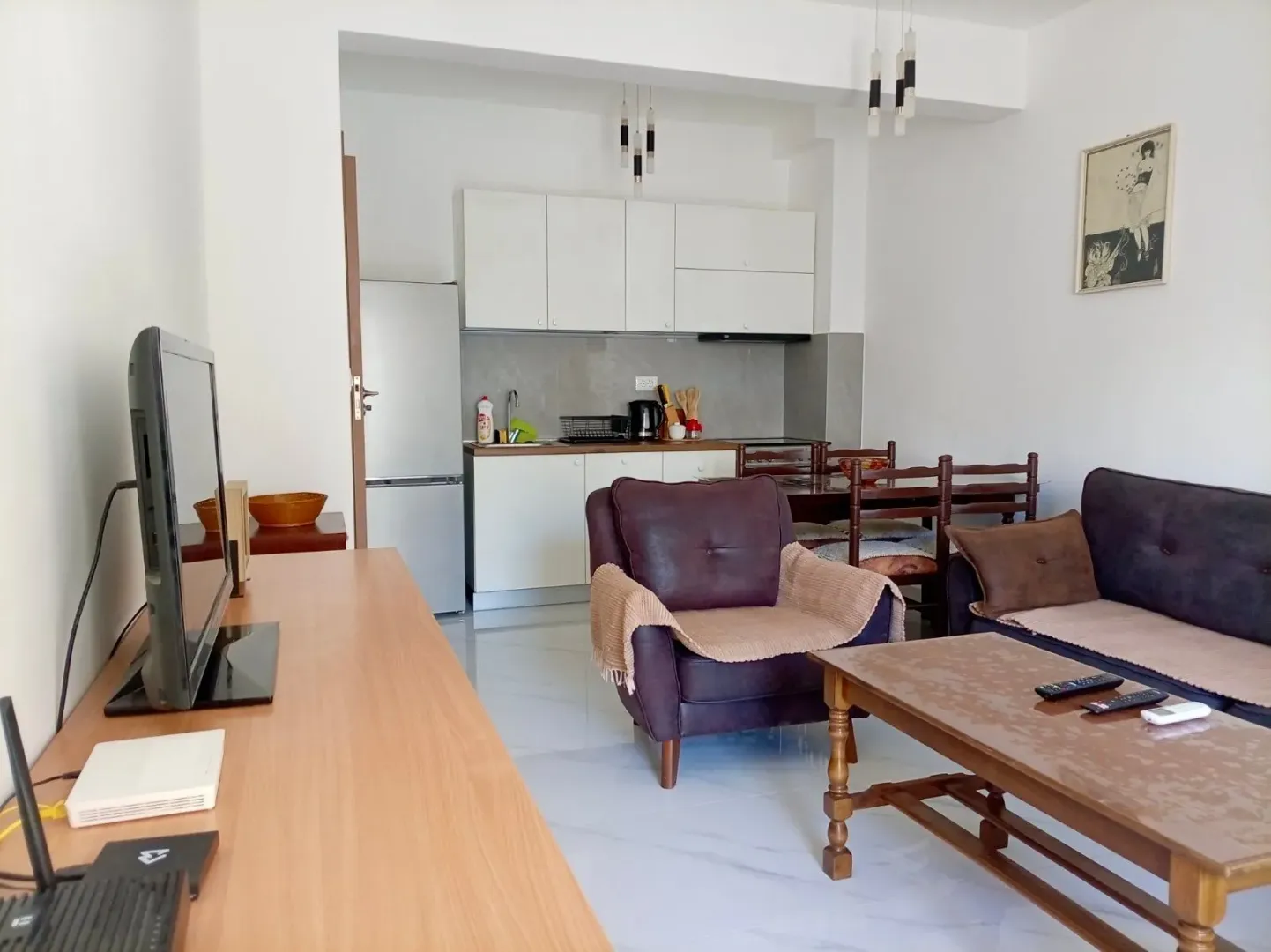 Living room with dining area and kitchen in the background.