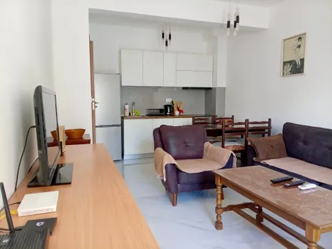 Living room with dining area and kitchen in the background. - image 3