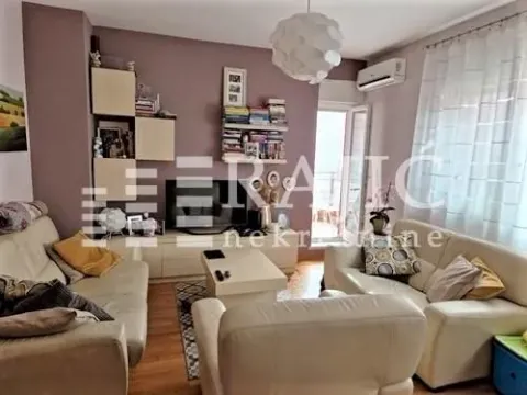 Living room with sofa set, TV, and access to the terrace. - image 3