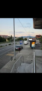 View from the stairs towards the street and surrounding buildings. - image 2