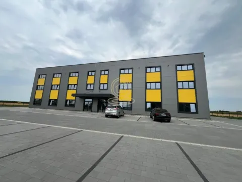 View of the exterior of the commercial building with parking in front. - image 2