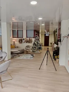 Spacious living room with a sofa set, television, and Christmas tree. - image 9