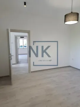 Empty room with light laminate flooring and an open door leading to another room. - image 6