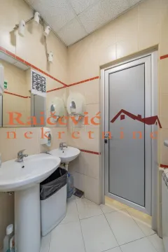 Bathroom with two sinks, a mirror, and a door. - image 16