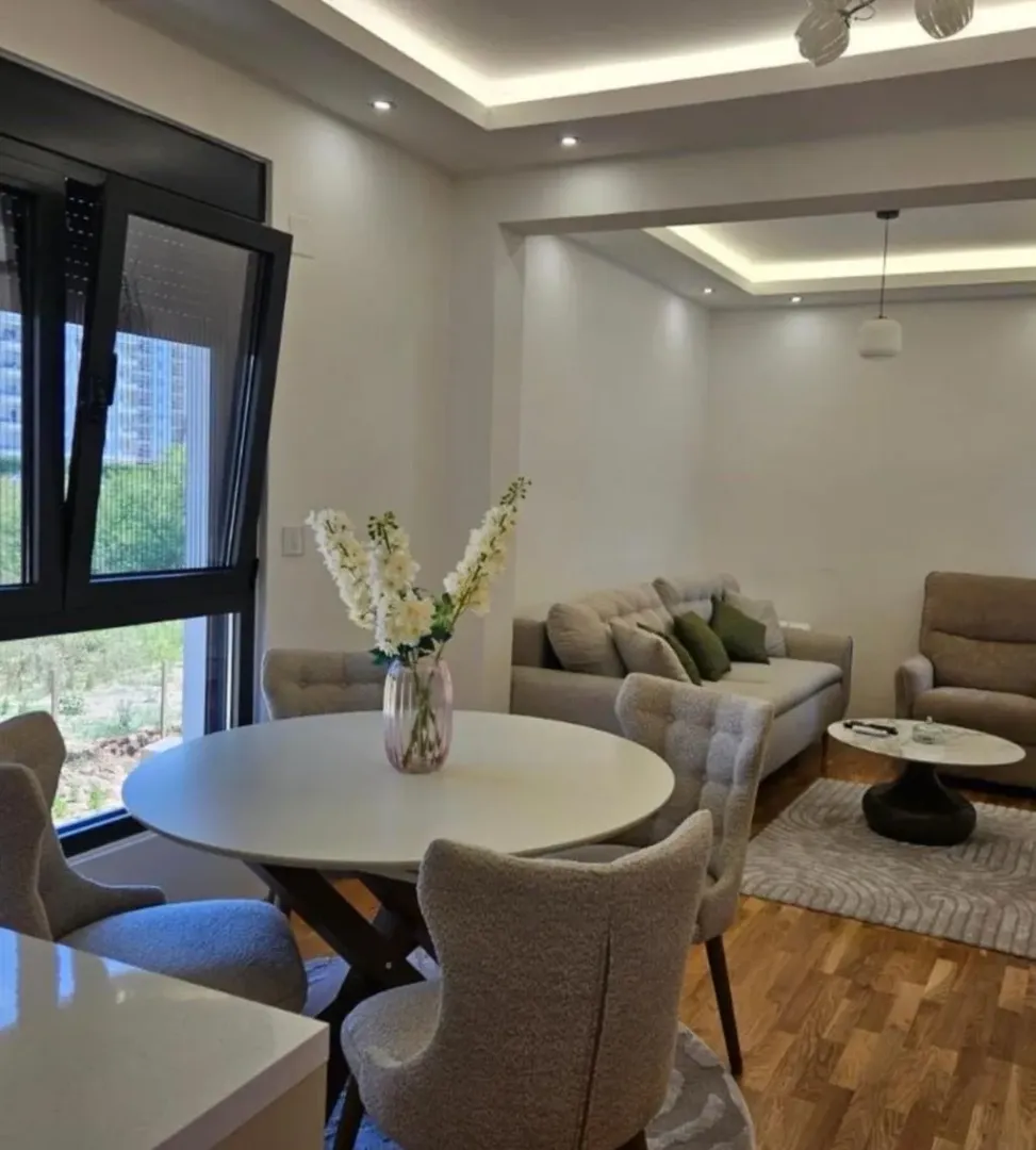 Living room with dining area and modern furniture.