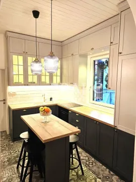 Modern kitchen with an island, wooden elements, and built-in lighting. - image 5