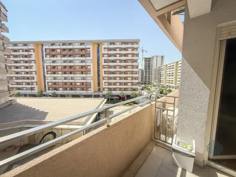 View from the balcony overlooking the surrounding residential buildings and neighborhood. - image 10