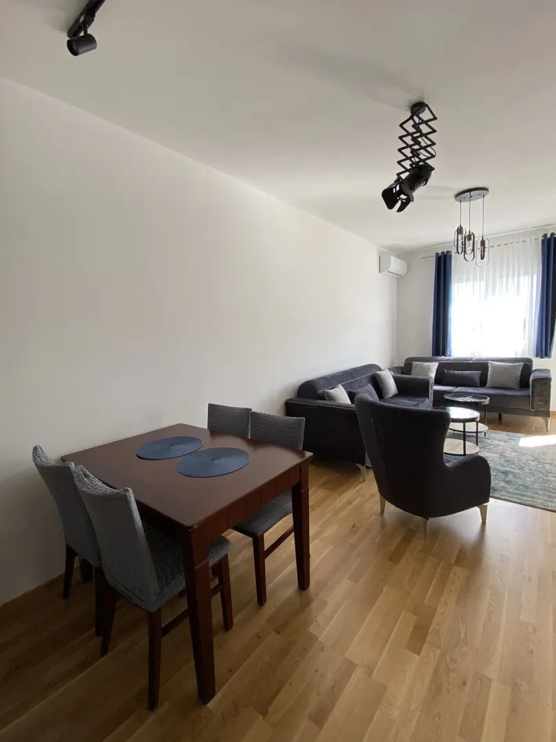 Bright living room featuring a dining table and comfortable seating options.