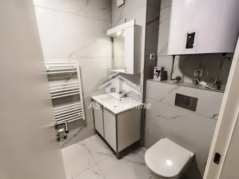 Modernly equipped bathroom with a shower cabin, washbasin, and toilet. - image 22