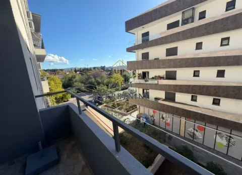 View from the balcony towards the adjacent building and surroundings. - image 2