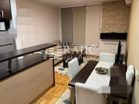Living room with a dining area and a breakfast bar in the apartment. - image 2