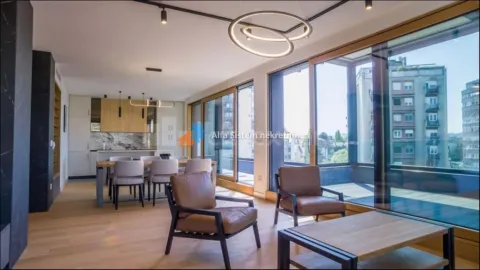 Spacious living room with a dining area and kitchen in the background, featuring large windows and access to the terrace. - image 20