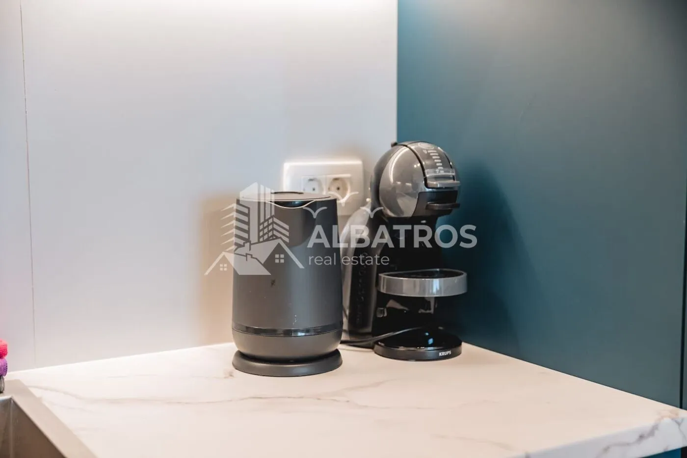 Kitchen counter with a coffee machine and an electric kettle.