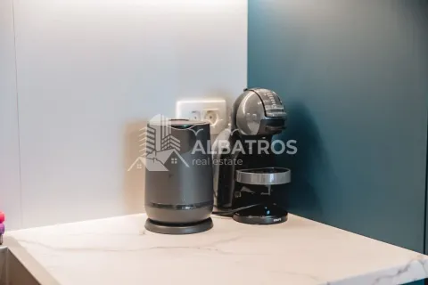 Kitchen counter with a coffee machine and an electric kettle. - image 13