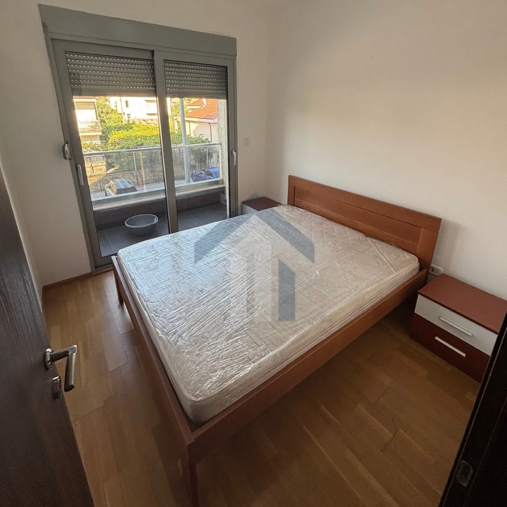 Bedroom with a double bed, bedside tables, and access to the terrace.