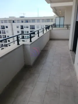 Spacious tiled balcony with a metal railing and a view of buildings. - image 5