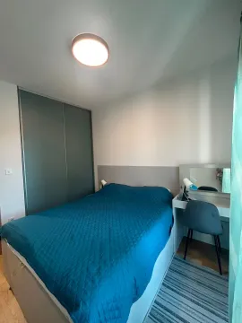 Furnished bedroom with a double bed, wardrobe, and a desk. - image 3