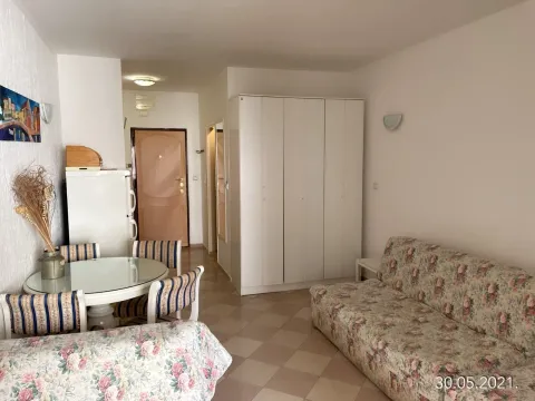 Living room with a dining area, a sofa, and a built-in wardrobe. - image 3