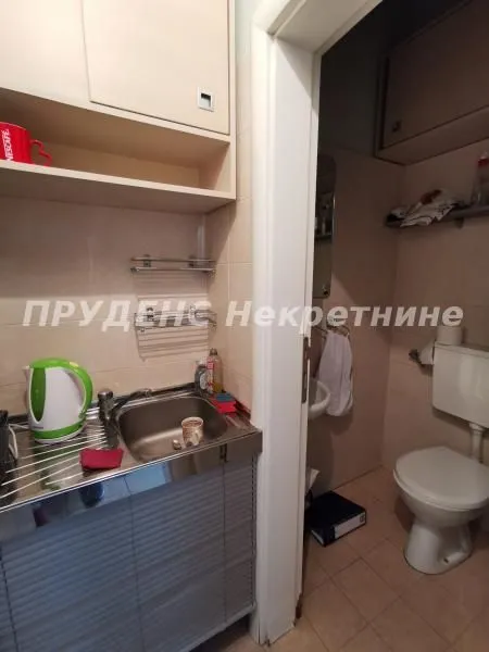 Small kitchen with a sink next to the entrance to the bathroom.