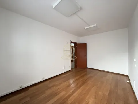 Empty room with wooden flooring and white walls. - image 7