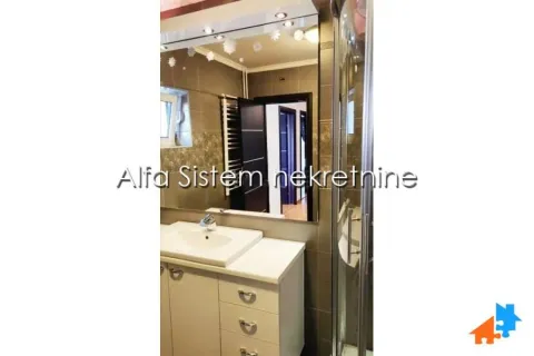 Bathroom with a sink, large mirror, and shower cabin. - image 21
