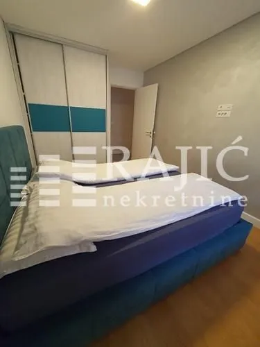 Furnished bedroom with a double bed and built-in wardrobe.