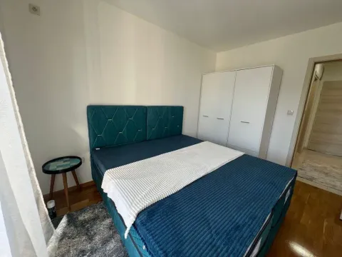 Bedroom with a double bed, wardrobe, and a bedside table. - image 5