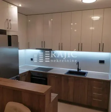 Modern kitchen with white and wooden cabinetry. - image 5