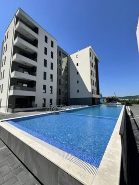 Exterior view of the residential building with a swimming pool in the courtyard. - image 2