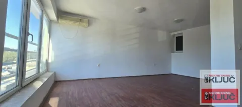 Empty room with hardwood floors and a large window. - image 16