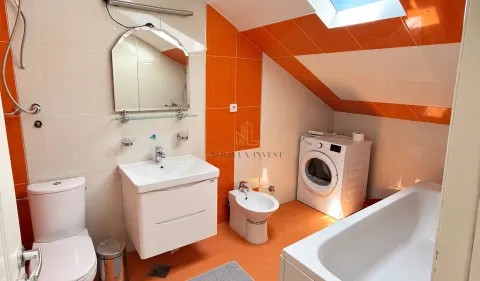Bathroom with a washbasin, toilet, bidet, bathtub and a washing machine. - image 11