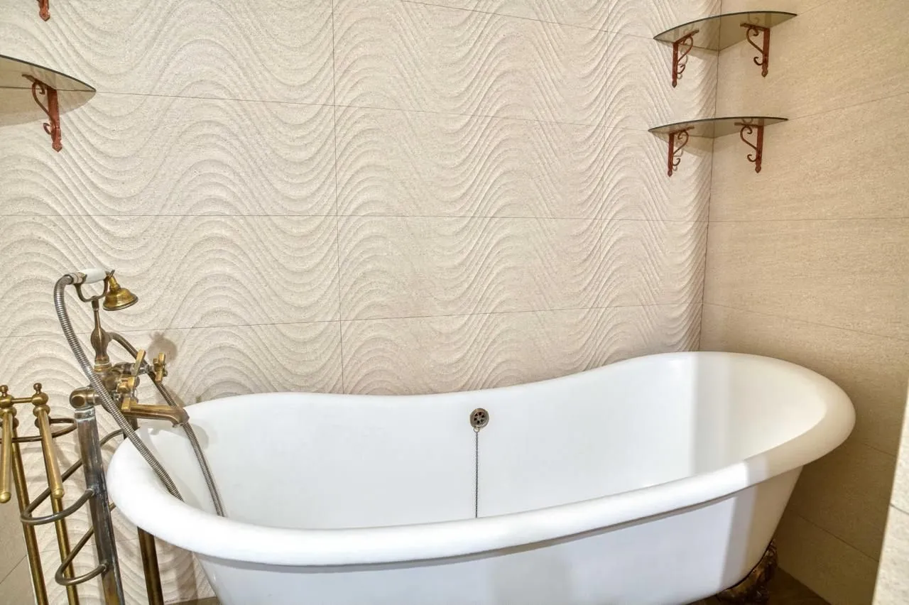 Bathroom with bathtub and vintage faucets.