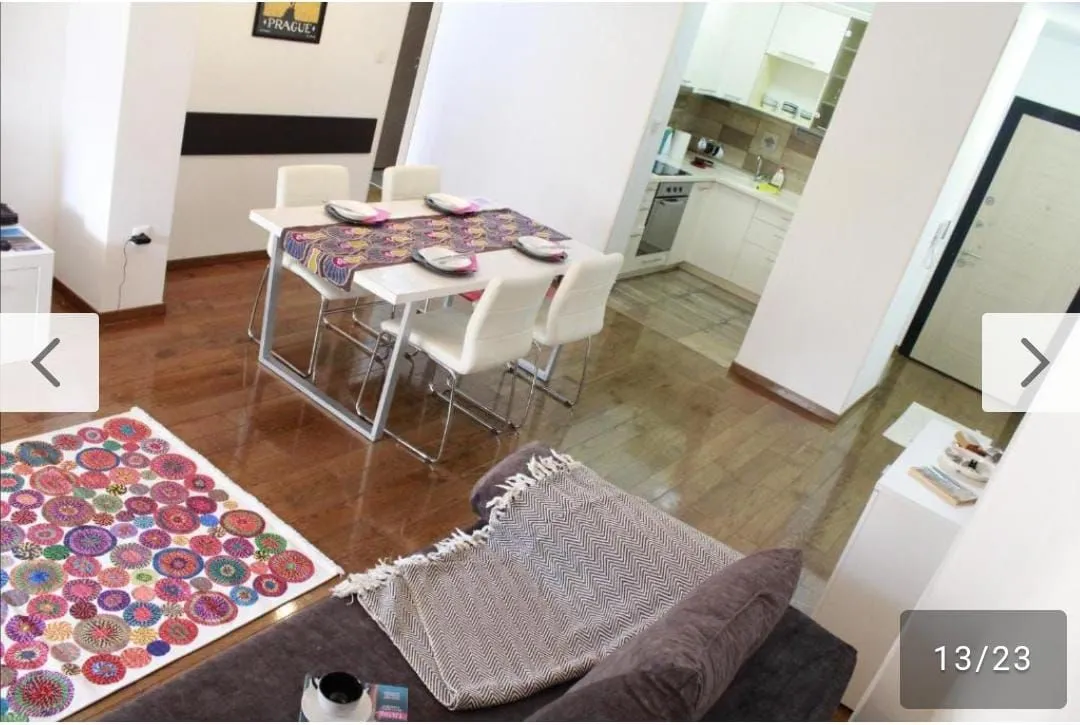 Living room with dining area and view of the kitchen.