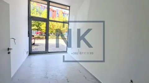 Empty room with a large glass storefront and white walls. - image 4