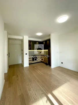 Compact kitchen as part of an open-plan living area with hardwood flooring. - image 6