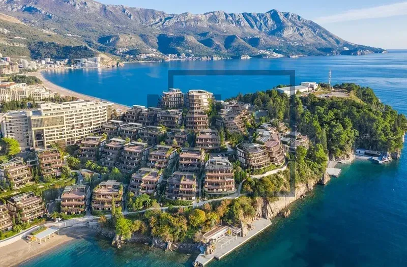 Aerial view of a hotel complex situated on the seashore.