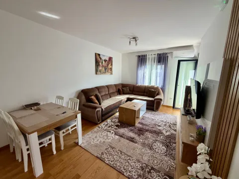 Spacious living room with a sectional sofa and a dining table. - image 9