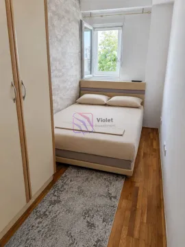 Small bedroom with a double bed, wardrobe, and hardwood flooring. - image 3