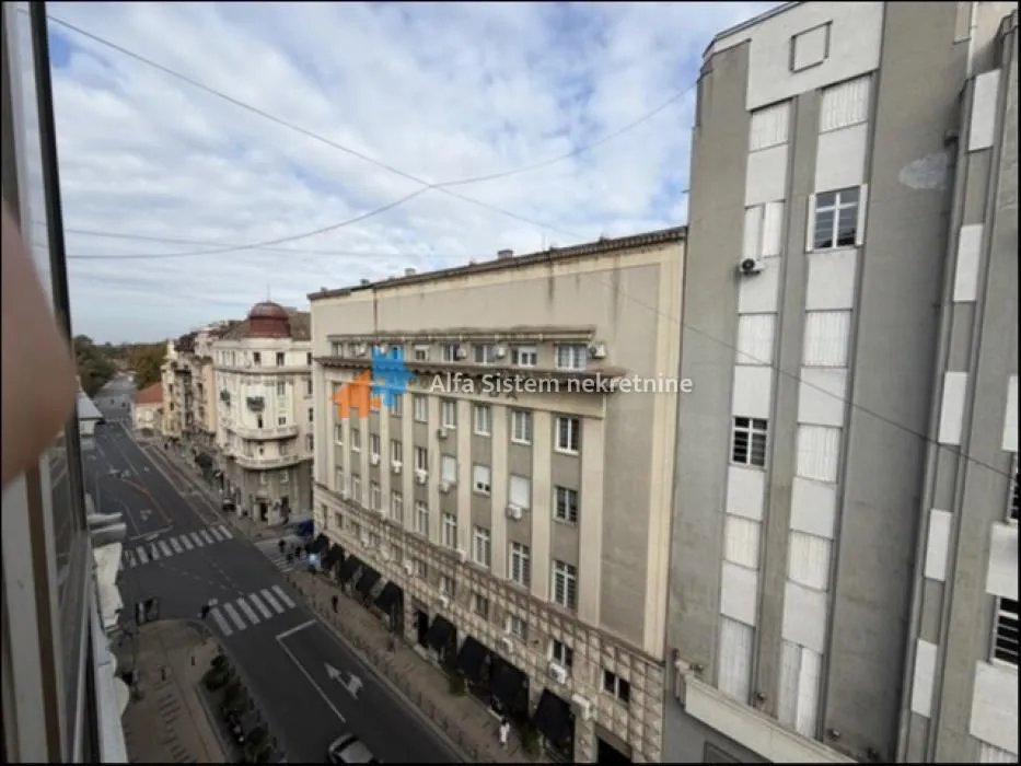 View from the window of the city street and surrounding buildings.