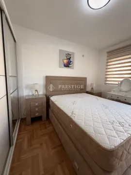 Furnished bedroom with a double bed, wardrobe, and nightstands. - image 8