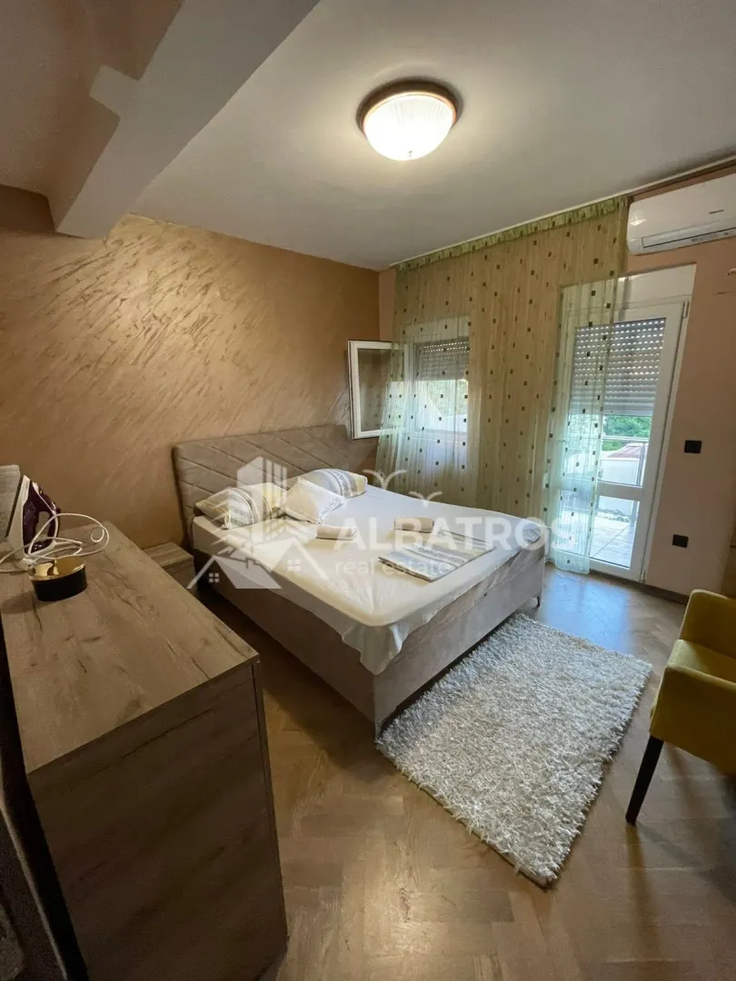 Furnished bedroom with a double bed, chest of drawers, and access to the terrace.