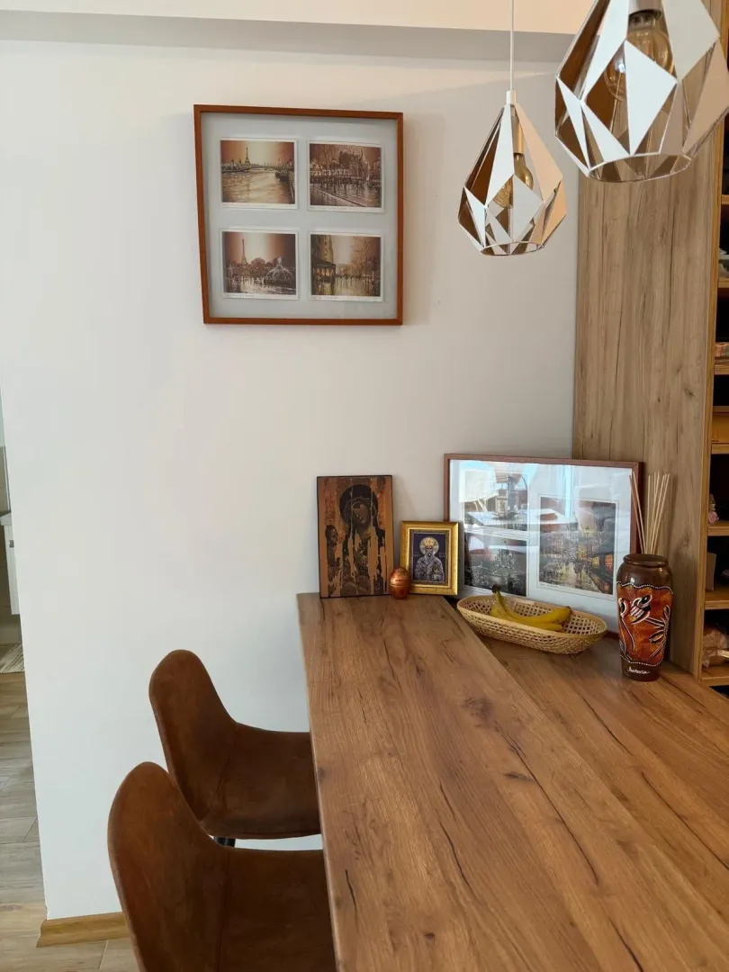 Dining area with a wooden table, chairs, and decorative items.