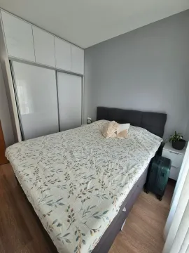 Bedroom with a double bed, built-in wardrobe, and nightstand. - image 19