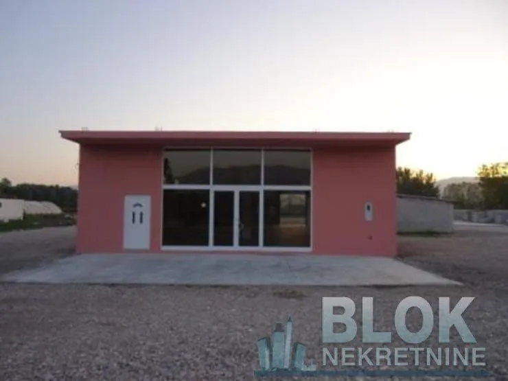 Exterior view of the commercial building with large glass entrance doors.