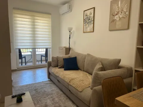 Living room with a comfortable beige sofa, coffee table and access to the terrace. - image 5
