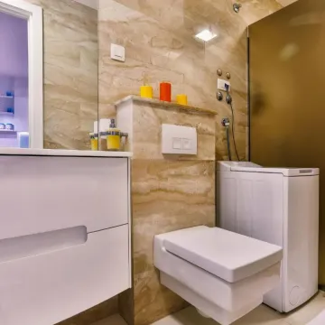 Modern bathroom with white sanitary ware and beige ceramic tiles. - image 6