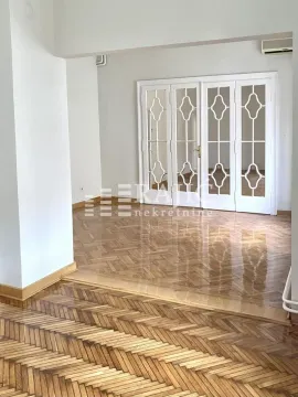 Living room with parquet flooring and white wooden doors. - image 7