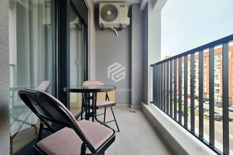 Furnished balcony with a table, chairs, and a view of the neighborhood. - image 2